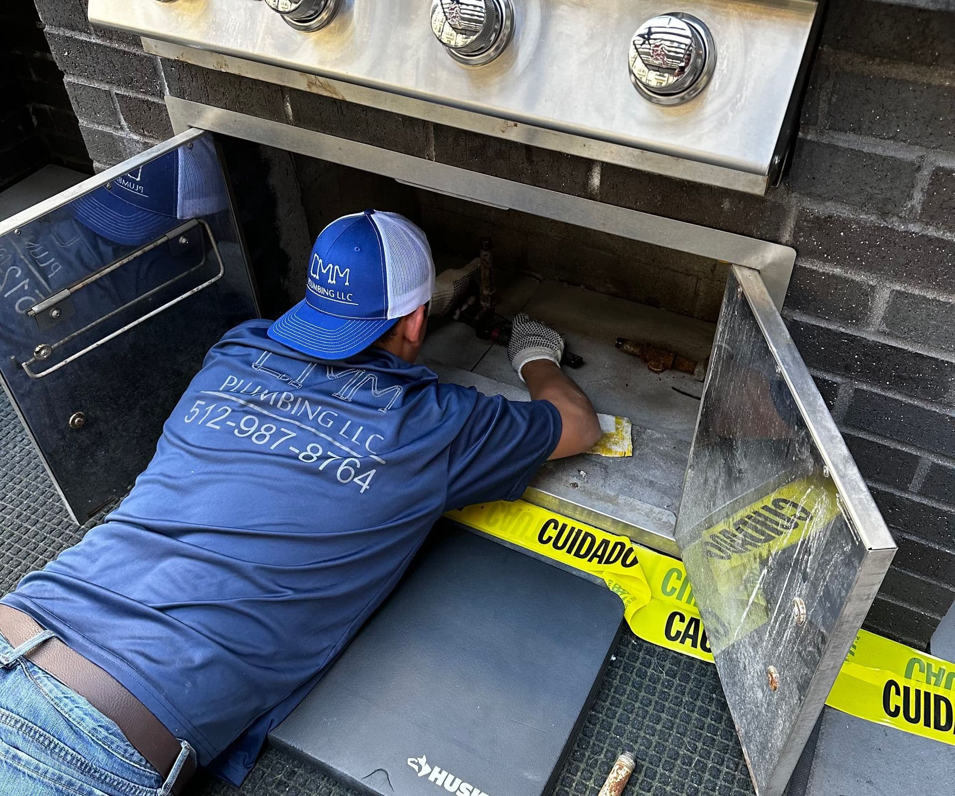 CMM Plumbing technician making a repair on-site