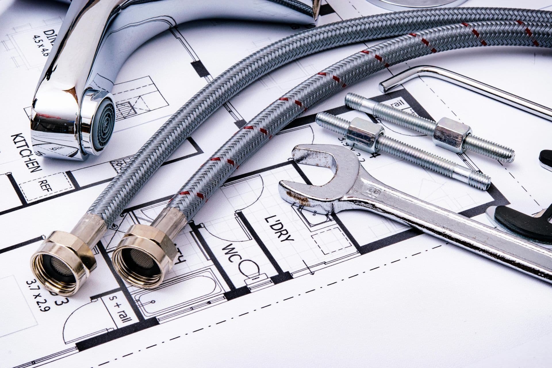 Plumber reviewing kitchen and bathroom plumbing layout plans for remodels in Coupland, TX