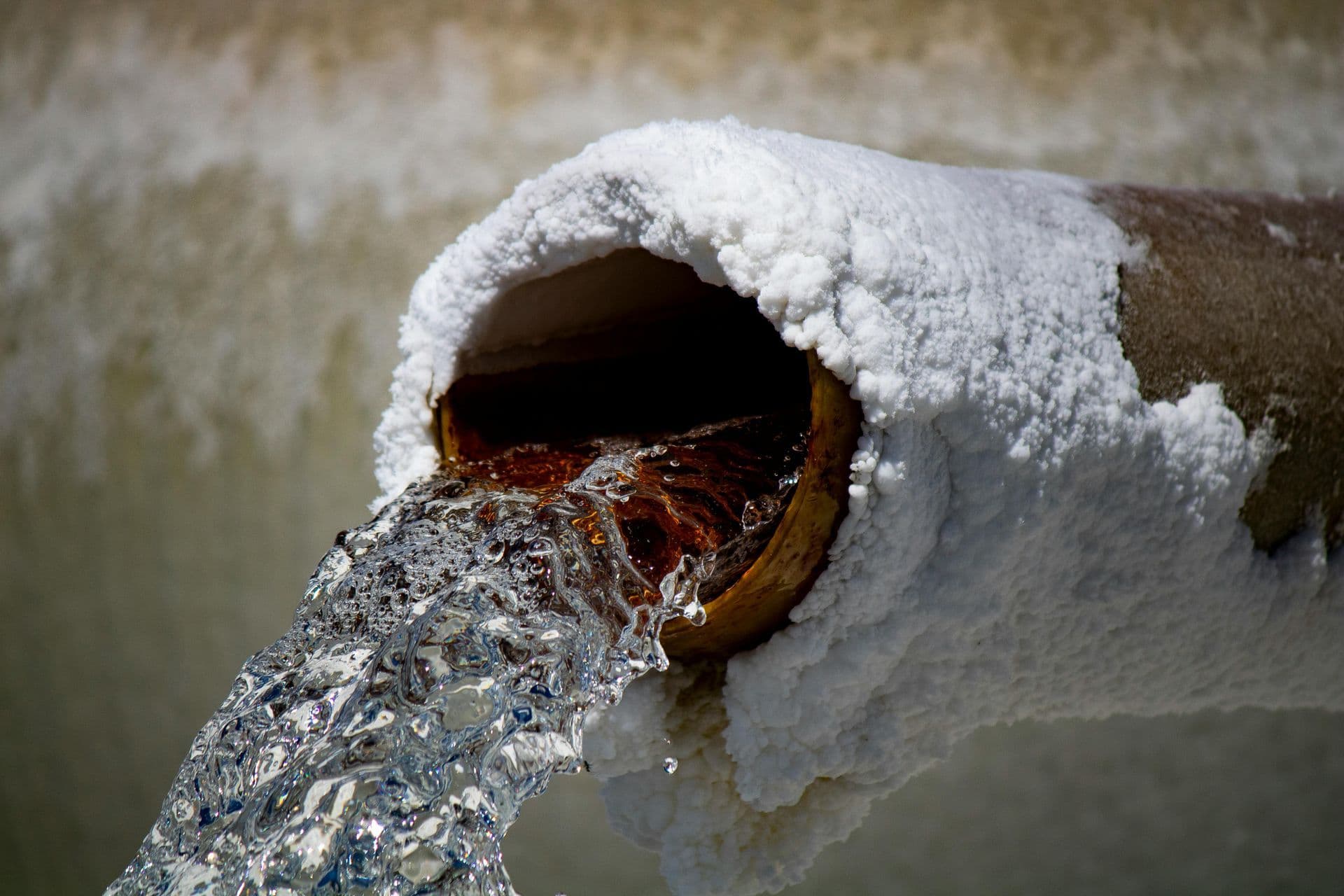 Discolored water from faucet indicating pipe corrosion and water quality issues