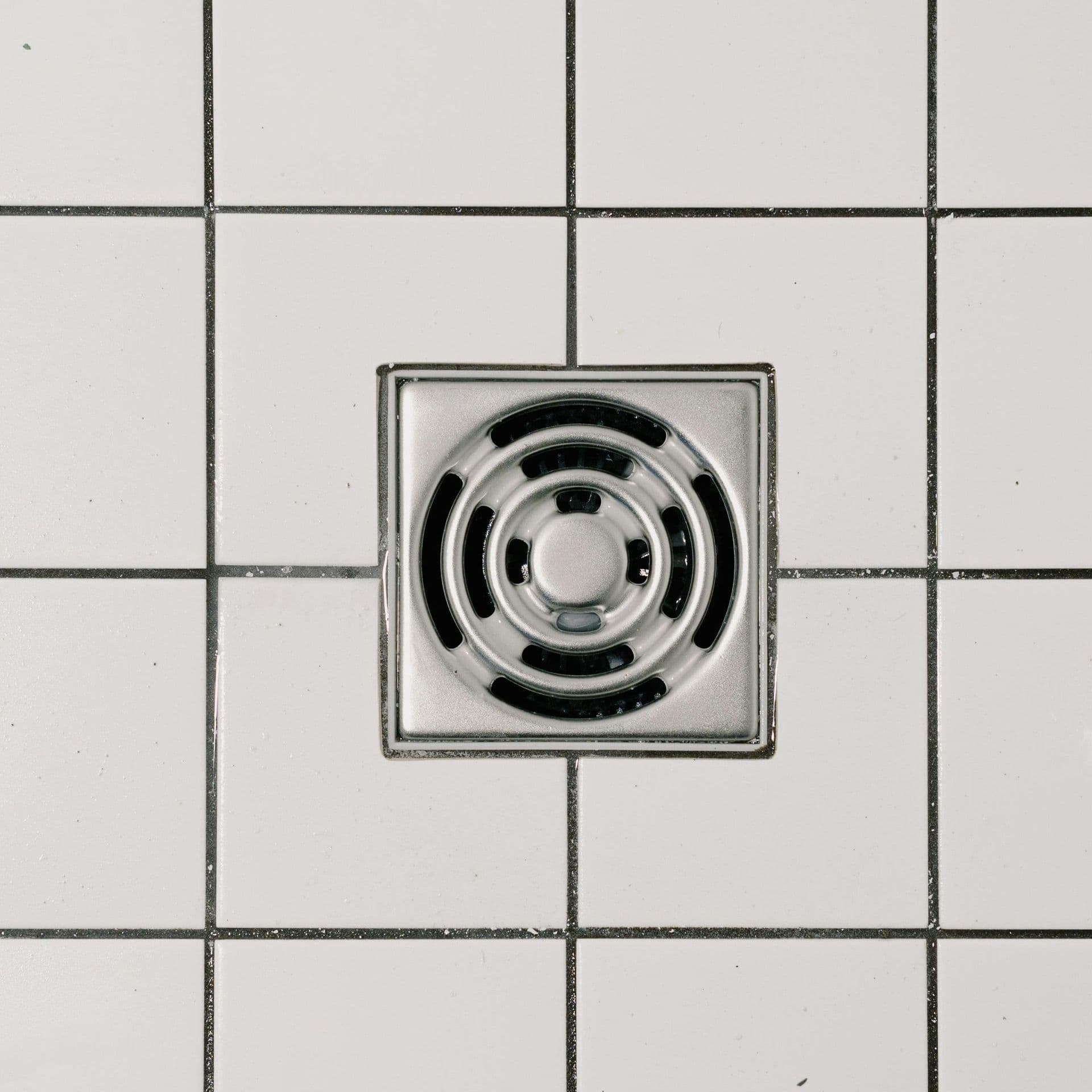 two people examining a water heater unit in a utility closet